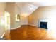 Bright living area featuring a fireplace, vaulted ceiling, and an open view to the kitchen at 6844 Saganaw Dr, Rex, GA 30273