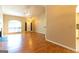 Open-concept living space with a fireplace, vaulted ceilings, and access to the front entrance at 6844 Saganaw Dr, Rex, GA 30273