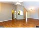 Open living room featuring vaulted ceiling, wood floor, and an arched view to the kitchen at 6844 Saganaw Dr, Rex, GA 30273