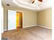 This large bedroom features tan walls, brown carpet, and a ceiling fan for a comfortable atmosphere at 6844 Saganaw Dr, Rex, GA 30273