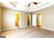 Spacious main bedroom featuring a tray ceiling, neutral paint, and doorways to the bathroom and closet at 6844 Saganaw Dr, Rex, GA 30273