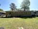 The backyard of a house, featuring a grassy lawn and a view of the home's exterior at 1089 Canal St, Decatur, GA 30032