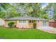 Charming single-story brick home featuring a well-manicured lawn and a cozy front porch at 1089 Canal St, Decatur, GA 30032