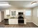 Renovated kitchen featuring stainless steel appliances, granite countertops, and white cabinetry at 1089 Canal St, Decatur, GA 30032