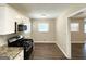Well-lit kitchen area featuring stainless steel appliances, granite counters, and tile flooring at 1089 Canal St, Decatur, GA 30032