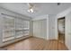 Bedroom with wood-look flooring, ceiling fan, closet, and large windows for natural light at 322 Wood Rdg, Peachtree City, GA 30269