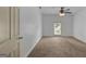 Spacious bedroom with a ceiling fan, a window, and soft carpet flooring for a cozy feel at 322 Wood Rdg, Peachtree City, GA 30269