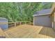 Spacious wooden deck offering serene views of the surrounding trees, perfect for relaxation and outdoor activities at 322 Wood Rdg, Peachtree City, GA 30269