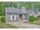 Traditional one story home featuring a gray exterior, shingled roof, and well-maintained lawn at 322 Wood Rdg, Peachtree City, GA 30269