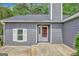 Inviting one story house with a gray facade, white trim, and a red front door at 322 Wood Rdg, Peachtree City, GA 30269