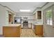 Well-lit kitchen features stainless steel appliances, wooden cabinets, and a skylight at 322 Wood Rdg, Peachtree City, GA 30269