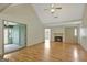 Spacious living room features hardwood floors, ceiling fan, fireplace, and access to sunroom at 322 Wood Rdg, Peachtree City, GA 30269