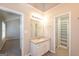 Bathroom with granite vanity, framed mirror, vinyl flooring, and walk-in closet at 7161 Bowie Dr, Lithonia, GA 30038
