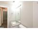 Bright bathroom featuring modern fixtures, framed mirror, and granite countertop at 7161 Bowie Dr, Lithonia, GA 30038