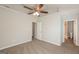 Neutral bedroom featuring carpet, ceiling fan, and doorways to bathroom and closet at 7161 Bowie Dr, Lithonia, GA 30038