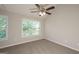 Neutral bedroom with plush carpeting, large window, and a ceiling fan at 7161 Bowie Dr, Lithonia, GA 30038