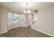 Bright dining area with bay windows, hardwood floors, and a chandelier at 7161 Bowie Dr, Lithonia, GA 30038