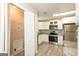 Efficient kitchen layout with white cabinetry, stainless steel appliances, and convenient laundry access at 7161 Bowie Dr, Lithonia, GA 30038