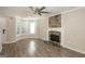 Inviting living room featuring a decorative stone fireplace, ceiling fan, and a large bay window at 7161 Bowie Dr, Lithonia, GA 30038