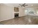 Spacious living room boasts a stone fireplace, ceiling fan, and ample natural light at 7161 Bowie Dr, Lithonia, GA 30038