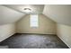 Finished attic with gray carpet, paneled walls, and window at 2361 Whites Mill Rd, Decatur, GA 30032