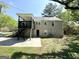 Two-story home featuring a covered deck, stone accents, and a grassy backyard at 2361 Whites Mill Rd, Decatur, GA 30032