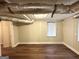 Finished basement features wood flooring and paneled walls at 2361 Whites Mill Rd, Decatur, GA 30032