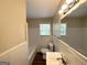 Clean, well-lit bathroom with white tile, modern fixtures, a vanity, and a large mirror at 2361 Whites Mill Rd, Decatur, GA 30032