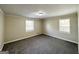 A neutral bedroom features gray carpet and two windows at 2361 Whites Mill Rd, Decatur, GA 30032