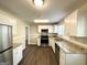 Well-lit kitchen boasting white cabinets, stainless steel appliances, granite countertops, and stylish flooring at 2361 Whites Mill Rd, Decatur, GA 30032