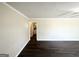 Bright living room featuring fresh paint, modern dark-stained flooring, and ample natural light at 2361 Whites Mill Rd, Decatur, GA 30032