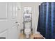 Bright bathroom featuring a toilet, shower with curtain and storage shelves at 3156 Oak Ridge Ln, Loganville, GA 30052