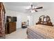 Bedroom featuring carpet, overhead ceiling fan, and wooden furniture at 3156 Oak Ridge Ln, Loganville, GA 30052