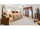 Cozy bedroom with plush carpeting, warm lighting, and decorative curtains for a relaxing retreat at 3156 Oak Ridge Ln, Loganville, GA 30052