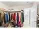Walk-in closet featuring an organized hanging system, storage shelves, and access to additional space at 3156 Oak Ridge Ln, Loganville, GA 30052