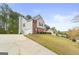 Two-story home featuring brick and siding, complemented by a concrete driveway and well-maintained lawn at 3156 Oak Ridge Ln, Loganville, GA 30052