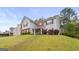 Two-story home with combination brick and siding facade, surrounded by green lawn and lush landscaping at 3156 Oak Ridge Ln, Loganville, GA 30052