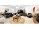 Open concept living room boasts neutral carpet, ample seating, and a decorative ceiling fan at 3156 Oak Ridge Ln, Loganville, GA 30052