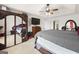 Serene main bedroom features a large bed, mounted TV, mirrored closet doors, and a ceiling fan at 3156 Oak Ridge Ln, Loganville, GA 30052