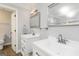Bathroom featuring double sink vanity with white cabinets, framed mirrors, modern light fixtures, and a toilet visible at 5082 Highland Hills Ct # 93, Stone Mountain, GA 30088