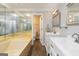 This bathroom features a large soaking tub, double vanity with cabinets, mirrors, and tile flooring at 5082 Highland Hills Ct # 93, Stone Mountain, GA 30088