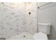 Modern bathroom features white, marble-look tiled shower and matching hexagon tile floor at 5082 Highland Hills Ct # 93, Stone Mountain, GA 30088