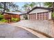 Charming home featuring a two-car garage and a well-maintained interlocking brick driveway, set amidst lush greenery at 5082 Highland Hills Ct # 93, Stone Mountain, GA 30088