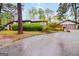 Landscaped front yard featuring mature trees and lush green bushes, providing privacy and curb appeal at 5082 Highland Hills Ct # 93, Stone Mountain, GA 30088