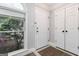Bright foyer featuring a large window, classic white door, and a convenient closet for storage at 5082 Highland Hills Ct # 93, Stone Mountain, GA 30088