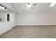 Spacious room with ceiling fan and tile floors leads to kitchen with stainless steel refrigerator at 5082 Highland Hills Ct # 93, Stone Mountain, GA 30088