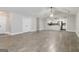 Open-concept living room with sleek tile floors, a vaulted ceiling, and a modern kitchen in the background at 5082 Highland Hills Ct # 93, Stone Mountain, GA 30088