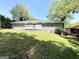 Exterior view of gray brick home with green lawn and mature trees at 3191 Gay Dr, Decatur, GA 30032