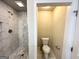 Bathroom featuring tiled shower and toilet at 3191 Gay Dr, Decatur, GA 30032