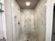 Bathroom with tiled shower stall, seat and rainfall shower head at 3191 Gay Dr, Decatur, GA 30032